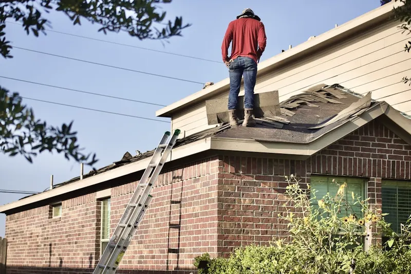 Professional roofer working on a residential roof in Johnson Park